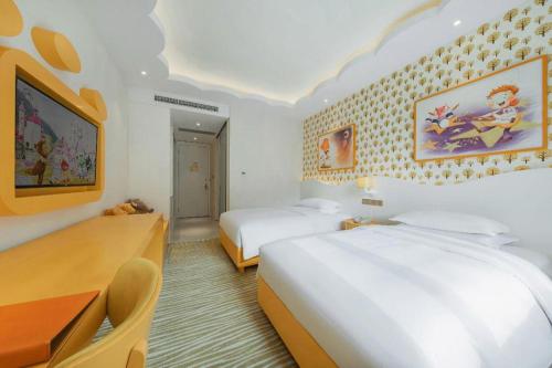 a hotel room with two beds and a desk at Deefly Yinrun Town Hotel in Deqing
