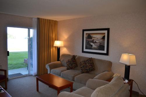 a living room with a couch and a table at Inn on Long Lake in Nanaimo