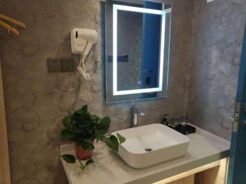 a bathroom with a sink and a mirror at City 118 Selected Hotel Xi'an Fengcheng Nan Road in Xi'an