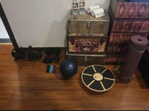 a room with a table and a ball on a wooden floor at James Joyce Coffetel Guilin Railway Station Xiangbi Mountain Liangjiang Sihu Wharf in Guilin