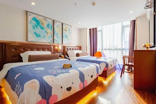 a hotel room with two beds in a room at James Joyce Coffetel Guilin Railway Station Xiangbi Mountain Liangjiang Sihu Wharf in Guilin
