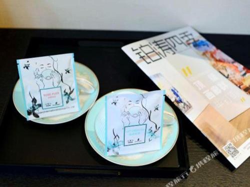 three plates on a table with a game at Xana Hotelle Xi'an Zhonglou, Huimin Street Metro Station in Xi'an