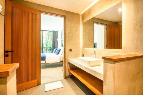 a bathroom with a sink and a mirror at New 4BR Villa 200m to the beach Canggu in Canggu