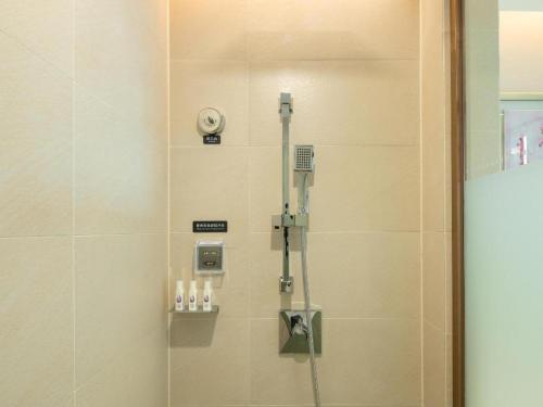 a shower stall in a bathroom with a shower at Lavande Hotel Zhongshan Xiaolan Taifeng in Jilong