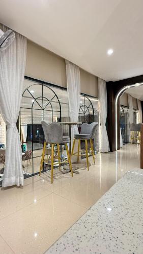 a dining room with two chairs and a table at Hotel Emperor Paradise in Bilāspur