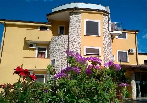 a building with flowers in front of it at Hotel Borgo Antico in San Severino