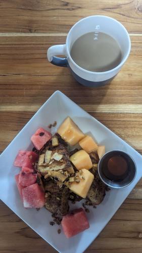 a plate of food on a table with a cup of coffee at La Bambouseraie in Balgue
