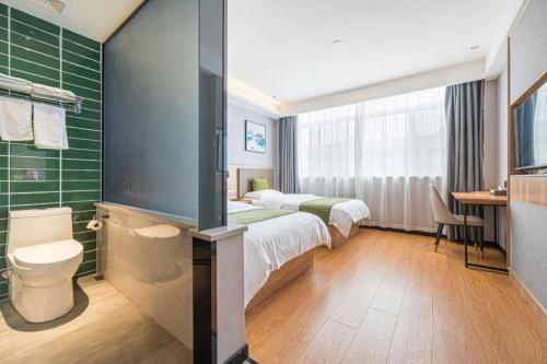 Ένα ή περισσότερα κρεβάτια σε δωμάτιο στο Green Tree Inn Anhui Tianchang Economic Development Zone