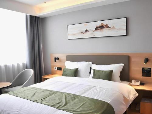 Ένα ή περισσότερα κρεβάτια σε δωμάτιο στο Green Tree Inn Anhui Tianchang Economic Development Zone