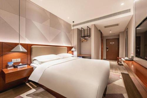 Ένα ή περισσότερα κρεβάτια σε δωμάτιο στο Borrman Hotel Xi'an North High-speed Railway Station