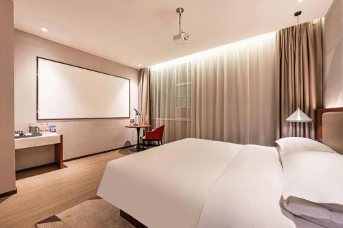 Ένα ή περισσότερα κρεβάτια σε δωμάτιο στο Borrman Hotel Xi'an North High-speed Railway Station