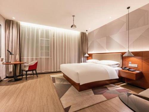 Ένα ή περισσότερα κρεβάτια σε δωμάτιο στο Borrman Hotel Xi'an North High-speed Railway Station