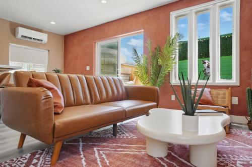a living room with a couch and a table at La Tierra House 15 Min to Beach Movie Lounge in Hawthorne