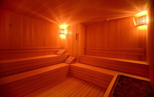 an empty sauna with benches and lights in it at Wyndham Grand Istanbul Levent Hotel & Conference Center in Istanbul