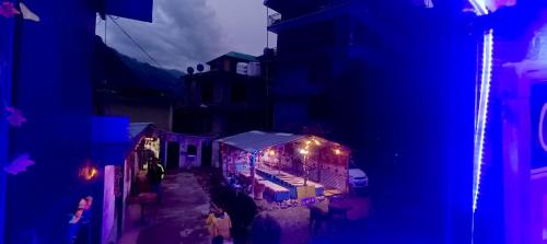 un grupo de personas caminando por una calle con luces en The North-East Breeze, en Jāmb