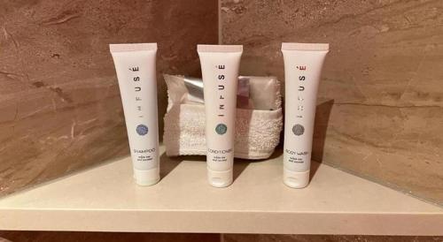 a group of four white bottles sitting on a shelf at Ahern Hotel and Event Center in Las Vegas