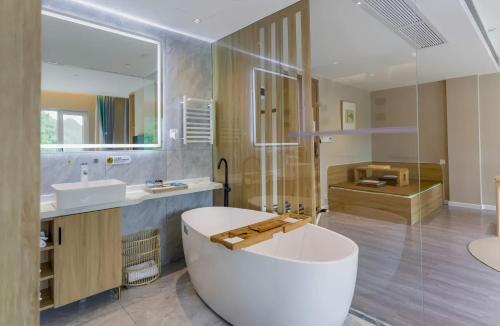 a large bathroom with a tub and a sink at 阳朔时间牧歌酒店Yangshuo Time Pastoral Hotel in Pai-sha