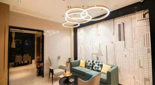 a living room with a couch and chairs and a chandelier at City Comfort Inn Changsha Sifangping University of National Defense Science and Technology in Changsha