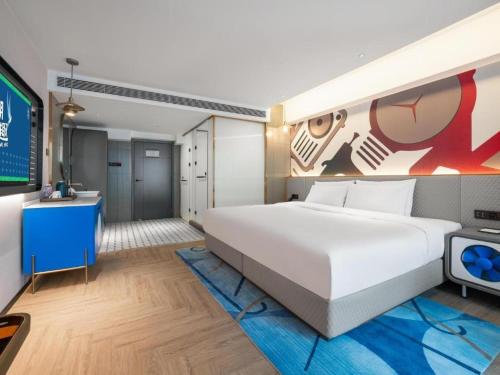 a bedroom with a large white bed and a tv at Y.TUO Hotel Universal Beijing Resort in Liyuanzhen