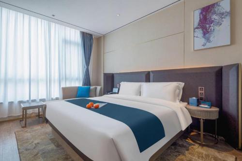 Ένα ή περισσότερα κρεβάτια σε δωμάτιο στο Echarm Hotel Zhuzhou Liling