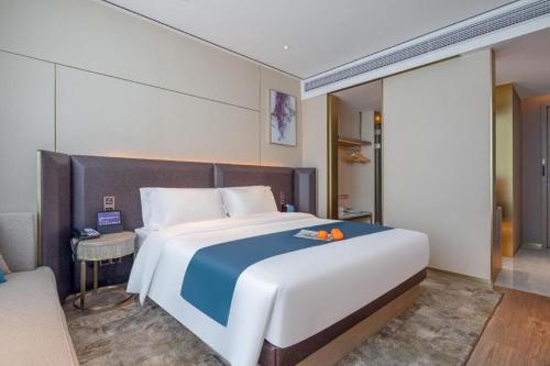 Ένα ή περισσότερα κρεβάτια σε δωμάτιο στο Echarm Hotel Zhuzhou Liling