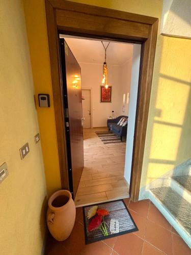 a hallway with a door open to a living room at ANTICA FILANDA Lattes in Cuneo