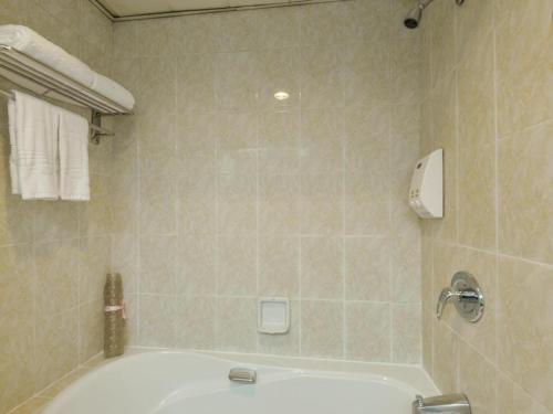 a bathroom with a bath tub and a sink at New Pearl River Hotel in Guangzhou
