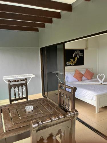 a bedroom with a bed with a large mirror at Karon Sea Sky Pool Apartment by 789property in Karon Beach