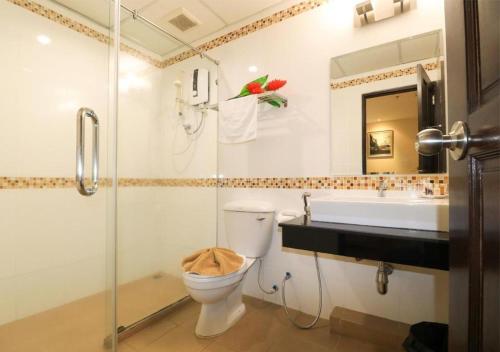 a bathroom with a toilet and a sink and a shower at G2 Hotel Group in Hat Yai