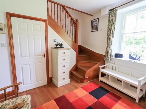 a room with a staircase and a white door at Drystones in Grasmere