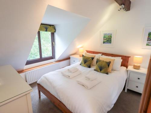 a bedroom with a bed with two towels on it at Drystones in Grasmere