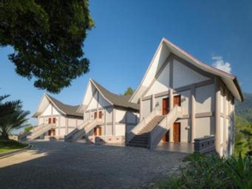 a large white building with a lot of windows at Hotel Niagara Parapat in Parapat