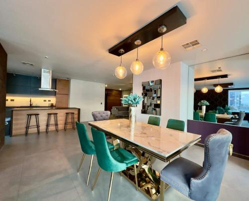 a dining room and kitchen with a table and chairs at Aqua Tower 3BR-3BA Beachfront Condo in Playas de Tijuana in Tijuana