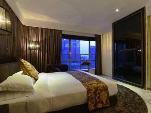 a bedroom with a large bed and a large window at Kingtown Hotel Hongqiao Shanghai in Shanghai