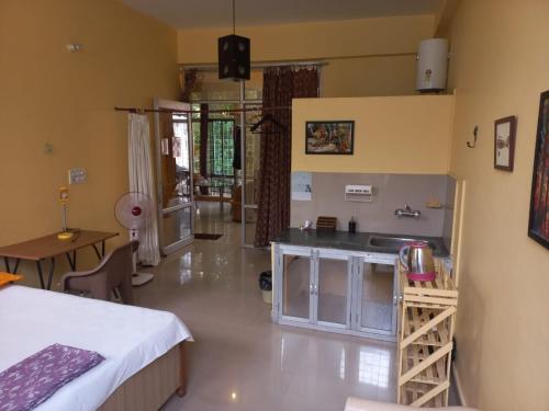a kitchen with a sink and a counter in a room at Devi music ashram in Rishīkesh