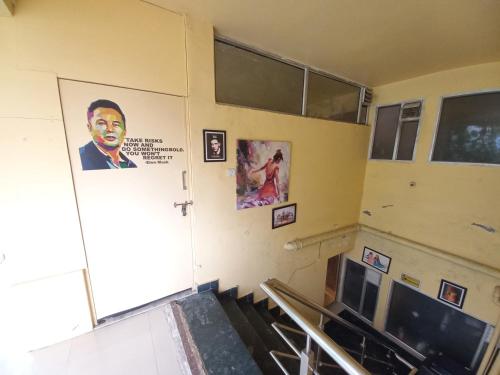 a room with a door with a picture of a man at Devi music ashram in Rishīkesh