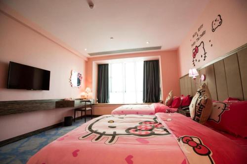 a pink bedroom with two beds and a flat screen tv at Landmark Hotel in Zhuhai