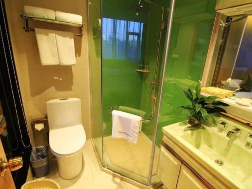 a bathroom with a shower and a toilet and a sink at GreenTree Inn Fuzhou Gulou District West Xierhuan Road Zuohai Park in Fuzhou