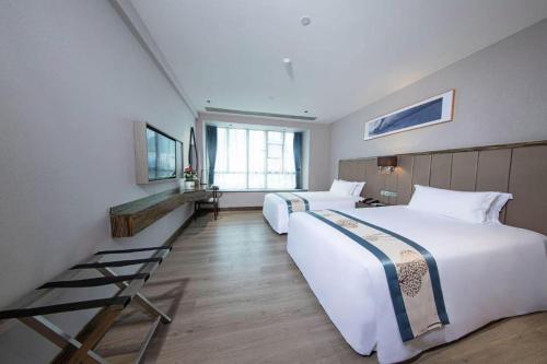 a hotel room with two beds and a staircase at Landmark Hotel in Zhuhai
