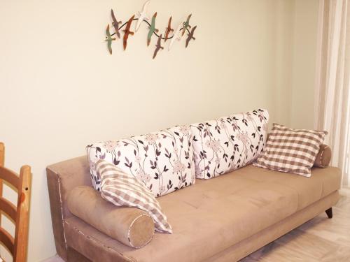 a couch with pillows on it in a living room at Saint Nicholas Beach Resort in Dassia