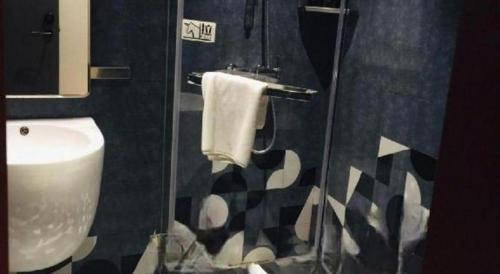 a bathroom with a toilet and a sink and a shower at YUNIK-Shanghai Zhongshan Park Yan'an Xi Road in Shanghai