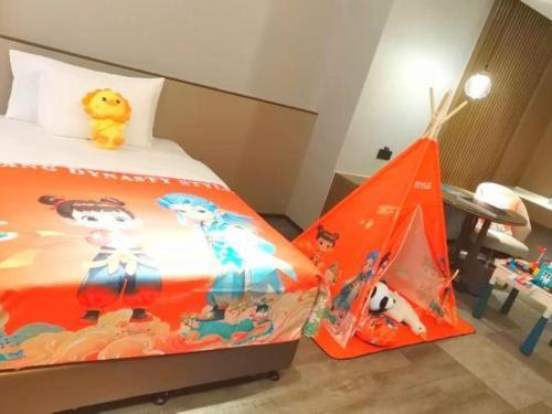 a bedroom with a bed with a toy tent at Wanda JIN Baise in Baise