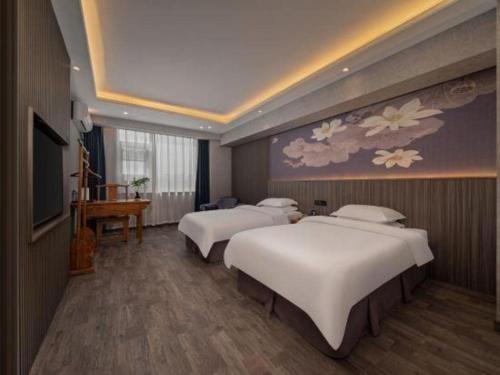Un ou plusieurs lits dans un hébergement de l'établissement Xi'an Huiya Tianmu Hotel