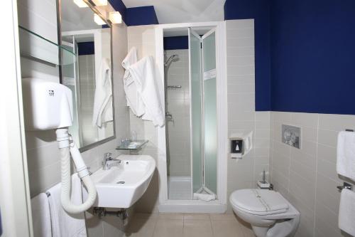 a bathroom with a sink and a toilet and a shower at Rigel Hotel in Catania