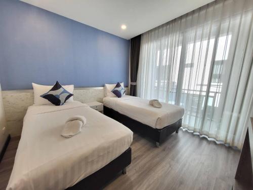 Ein Bett oder Betten in einem Zimmer der Unterkunft Irin Beach Cha-am