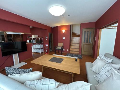 a living room with a couch and a table at 10-minute drive to Asahiyama Zoo, for up to 10 people, with parking lot in Asahikawa