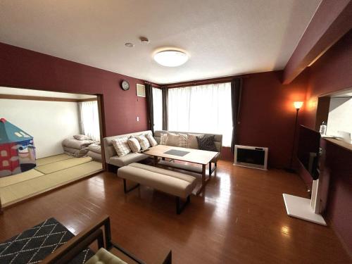 a living room with a couch and a table at 10-minute drive to Asahiyama Zoo, for up to 10 people, with parking lot in Asahikawa