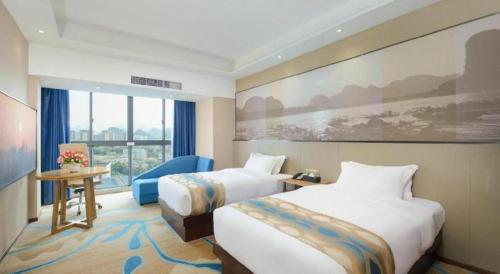 a hotel room with two beds and a window at Guilin Manhatton Hotel Tianjie in Guilin