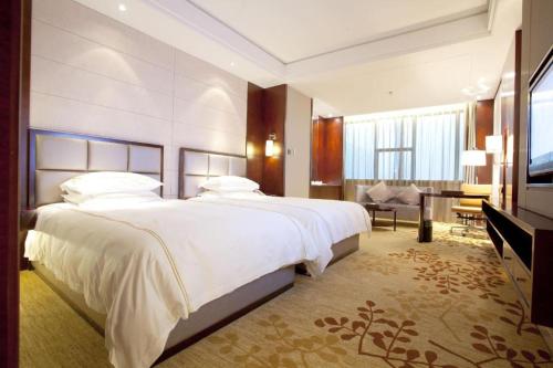 a hotel room with a large bed and a television at Winnerway hotel in Dongguan