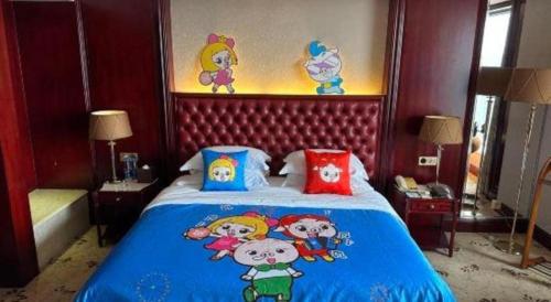 a bedroom with a large blue bed with cartoons on it at King Century Hotel in Zhongshan